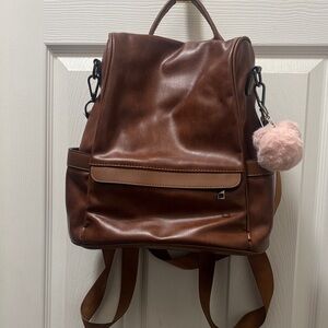 Brown Leather Backpack with Pom Pom. HARDLY USED. CAN ALSO USE AS DIAPER BAG.